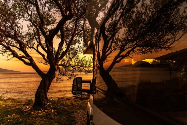 Scenic Sea Front RV Park Camping Pitch with a Tree During Sunset
